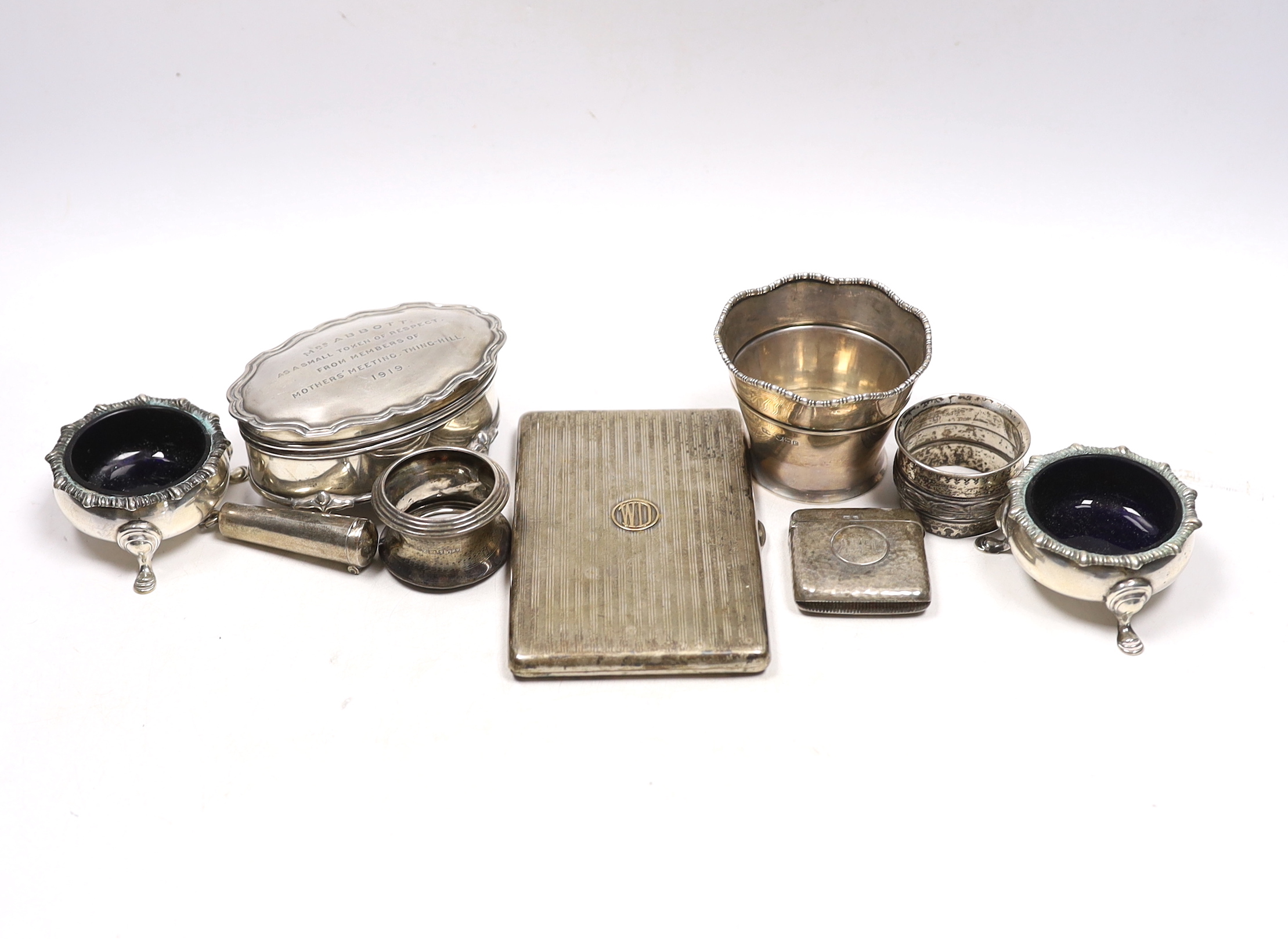 Sundry small silver including an Asprey silver cigarette case, 12.7cm, napkin ring, trinket box, pair of salts, vesta, small vase and a cheroot holder case, together with a plated napkin ring.